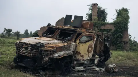 Getty Images A destroyed armoured vehicle is seen following clashes in the outskirts of Goma on February 2, 2025.